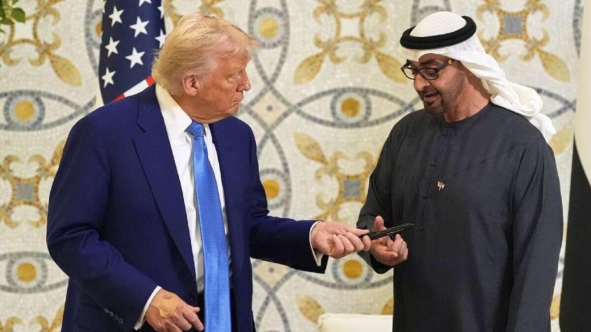 US President Donald Trump hands a pen to UAE President Mohammed bin Zayed Al Nahyan after signing the guest book at Qasr Al Watan in Abu Dhabi on May 15.