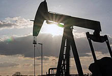 Silhouette of an oil pump jack against the sunset sky, symbolising global petroleum trade and sanctions