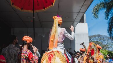 Image shows groom seated on a horse during a baarat procession