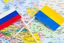 An image featuring the flags of Russia and Ukraine with a world map in the background