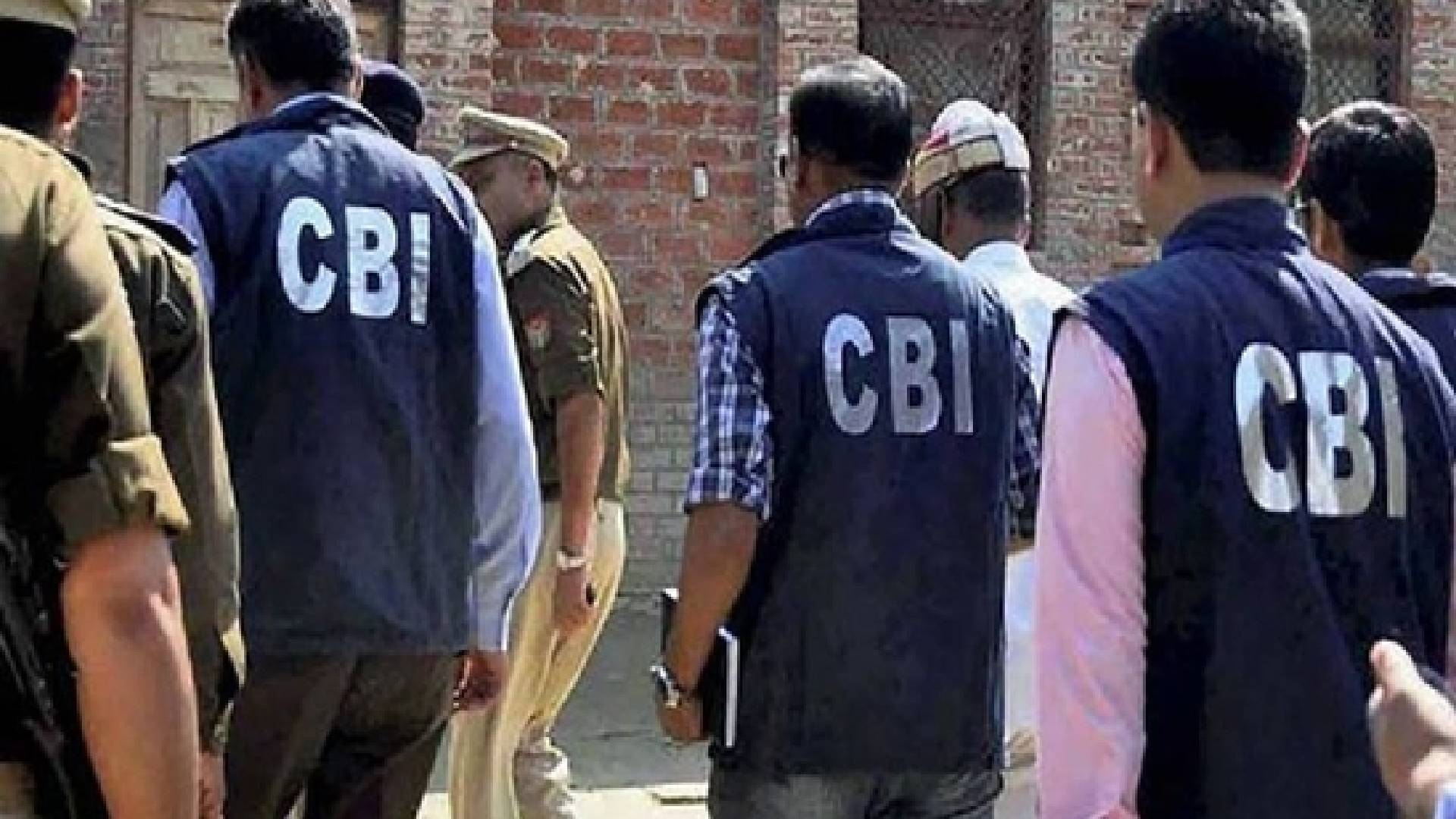 The image of a CBI officers, wearing jackets marked