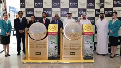 The image of a officials and staff at Dubai Duty Free pose with the Millennium Millionaire draw machines for Series 505 and 506.