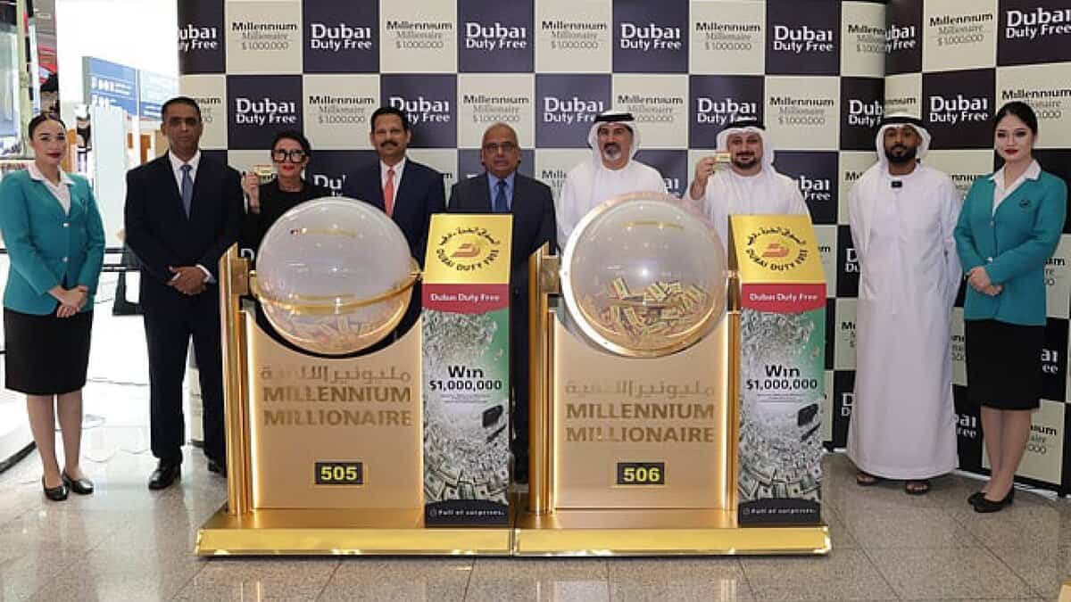 The image of a officials and staff at Dubai Duty Free pose with the Millennium Millionaire draw machines for Series 505 and 506.