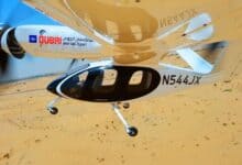 The image of a Joby Aviation’s electric aerial taxi with Dubai government branding seen mid-flight over a desert landscape during its first successful test.