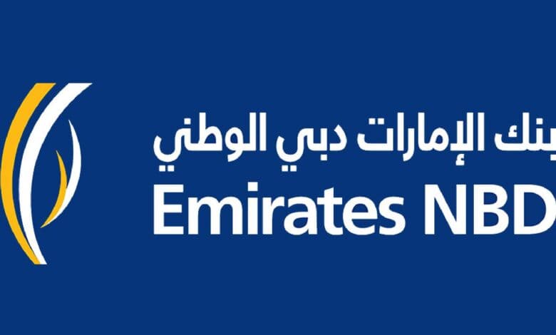 The image of a logo featuring the text "Emirates NBD" in white on a blue background, with Arabic text above and a stylised yellow and white design on the left.