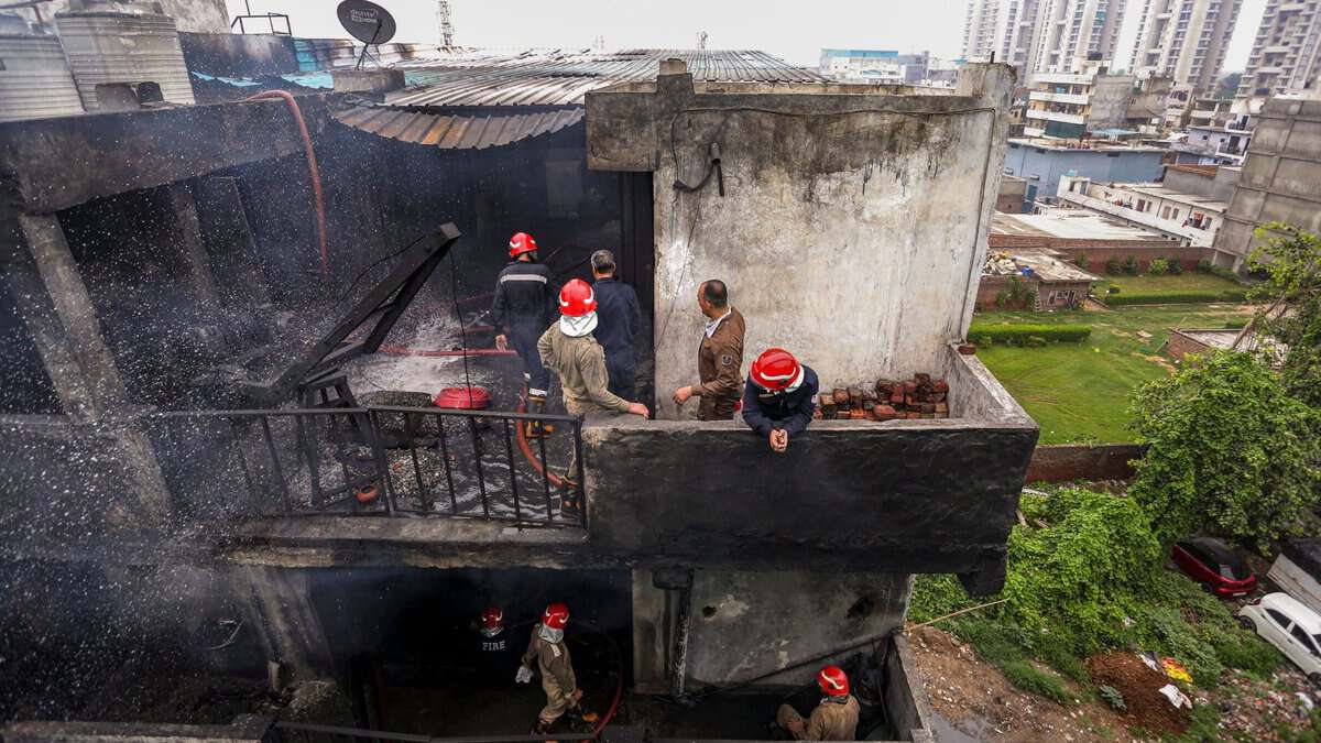 _Firefighters carry a victim's body after a fire broke out in a chemical factory