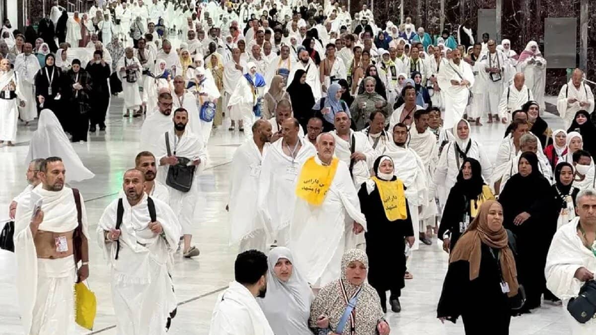 Muslim pilgrims walk through the Grand Mosque in Makkah ahead of Haj 2025, dressed in traditional Ihram clothing.