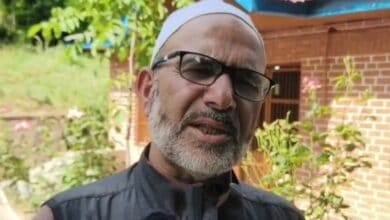 Image of Gulzar Hussain speaking to local media
