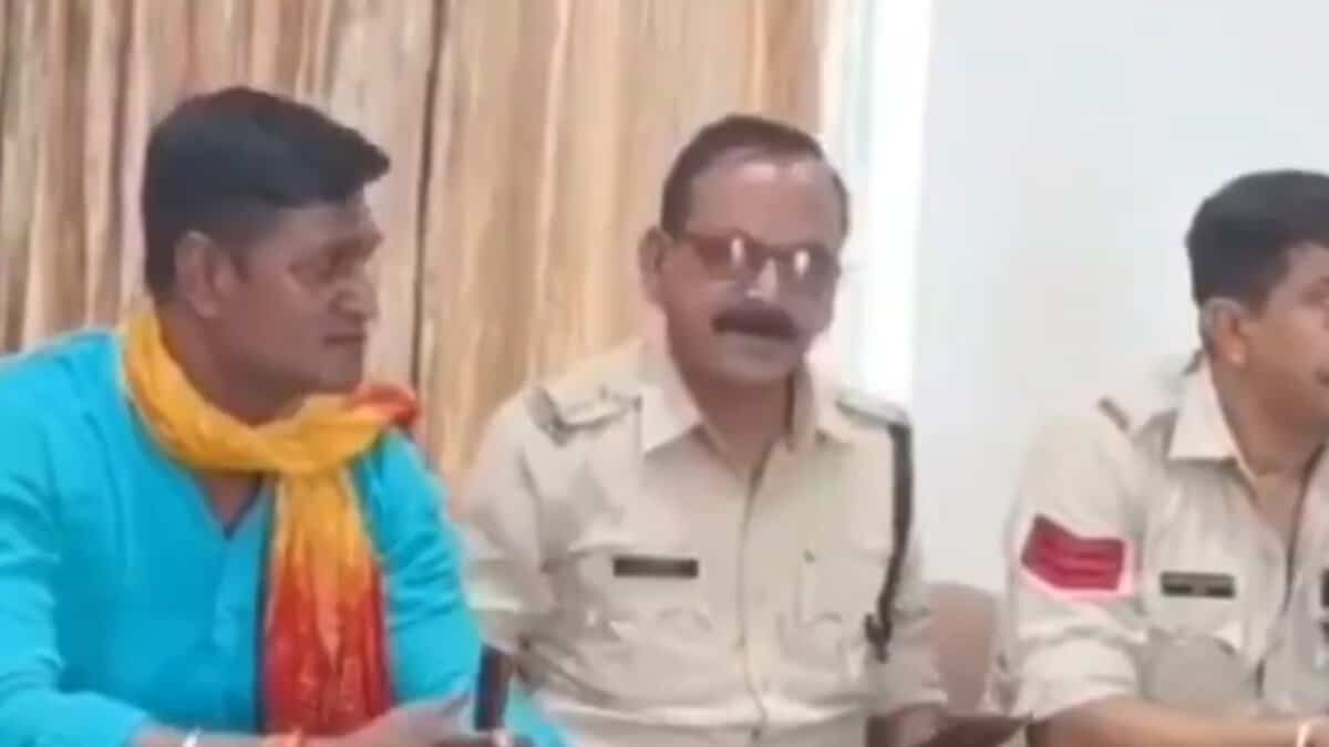 Image shows a sub-inspector in MP with fellow officers after police were called to defuse tensions sparked by Bajrang Dal members objecting to Muslim trainers at a gym in Bhopal.
