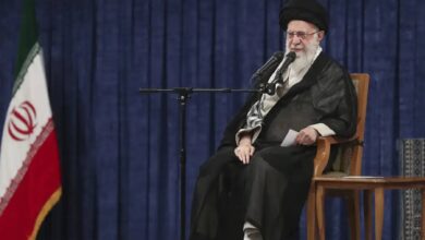 The image of a Iran’s supreme leader Ayatollah Ali Khamenei while delivering a televised address seated next to the national flag.
