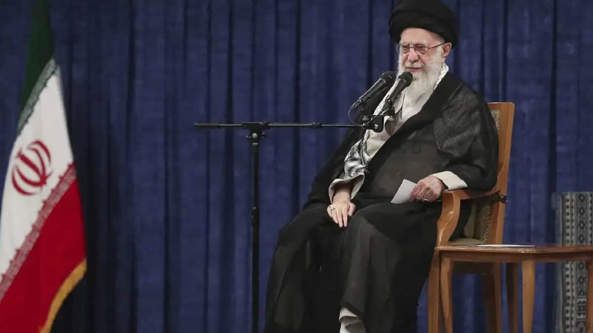 The image of a Iran’s supreme leader Ayatollah Ali Khamenei while delivering a televised address seated next to the national flag.