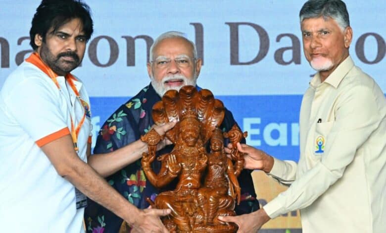PM Modi with Andhra Pradesh CM Chandrababu Naidu and DyCM Pawan Kalyan holding a wooden idol at an event for #IDY2025.