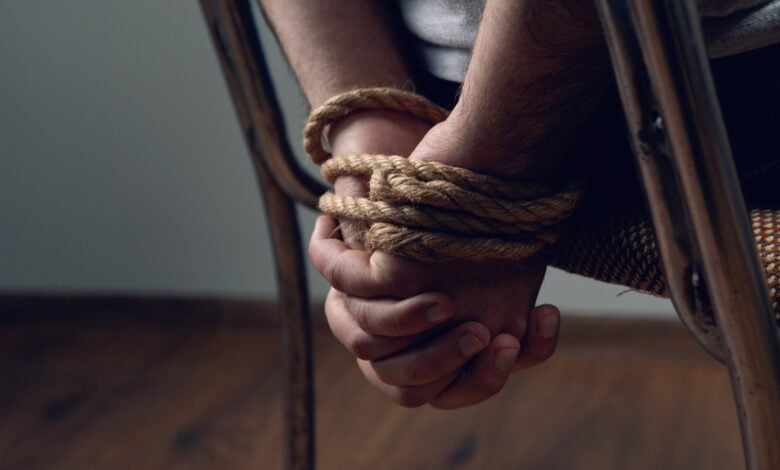 Representational image of a man tied with rope, symbolizing a kidnapping.