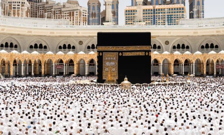 A large crowd of pilgrims gathers around the Kaaba at the Grand Mosque in Makkah during Umrah.