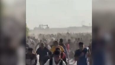 The image displays a picture of Palestinians running for their life as Israeli army opened fire in Gaza Strip