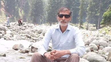 The image displays a picture of a Kashmiri man killed in an accident