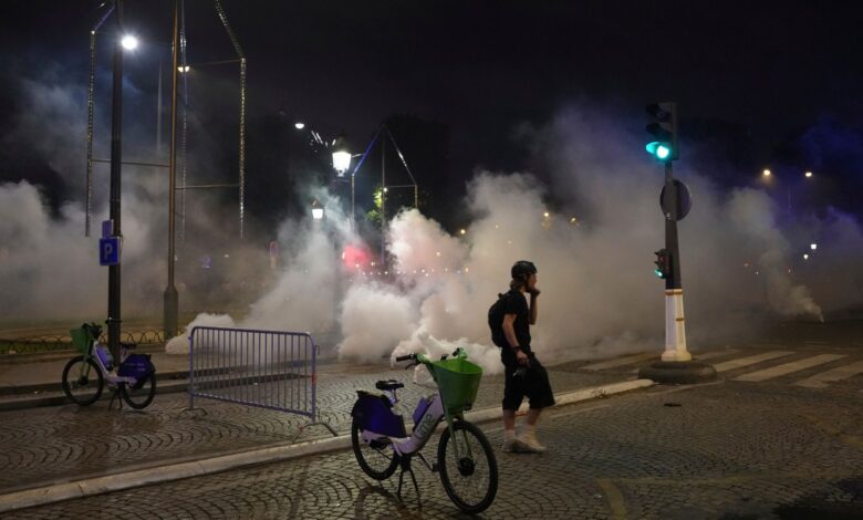 A man walks past tear gas during incidents after the Champions League final soccer match between Paris Saint-Germain and Inter Milan on Sunday in Paris.