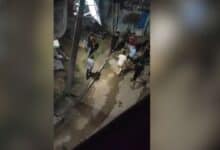 The image displays a picture of young men with sticks in Bihar