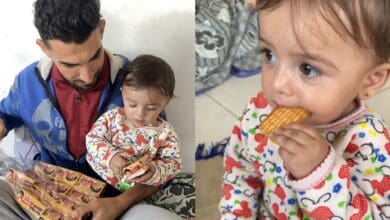 The image displays a picture of a Gaza father giving Parle-G biscuits to his toddler daughter