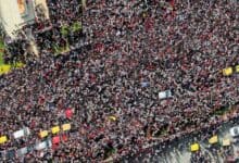 The image displays a picture of Crowd gathered outside the vidhan soudha in Bengaluru before the stampede