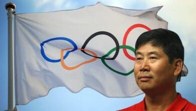 The image displays a picture of Olympics flag in the background and Legendary Korean coach KiSik Lee in the front