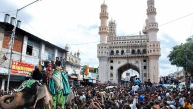 The image displays a file picture of Bibi-ka-Alam procession for Muharram in Hyderabad