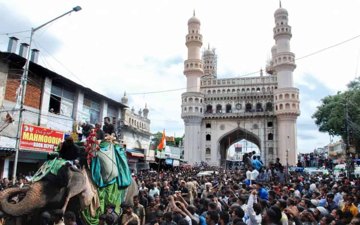 The image displays a file picture of Bibi-ka-Alam procession for Muharram in Hyderabad