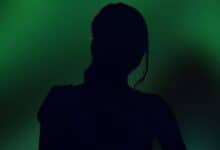 The image displays a picture of a woman with green background