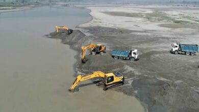 The image displays a picture of illegal sand mining in Chhattisgarh
