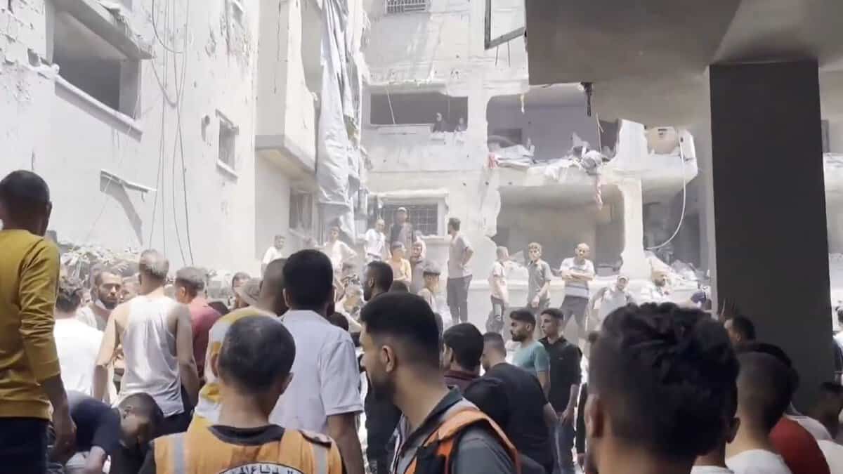 The image displays a devastation after an Israeli strike killed at least 16 Palestinians on the Gaza Strip