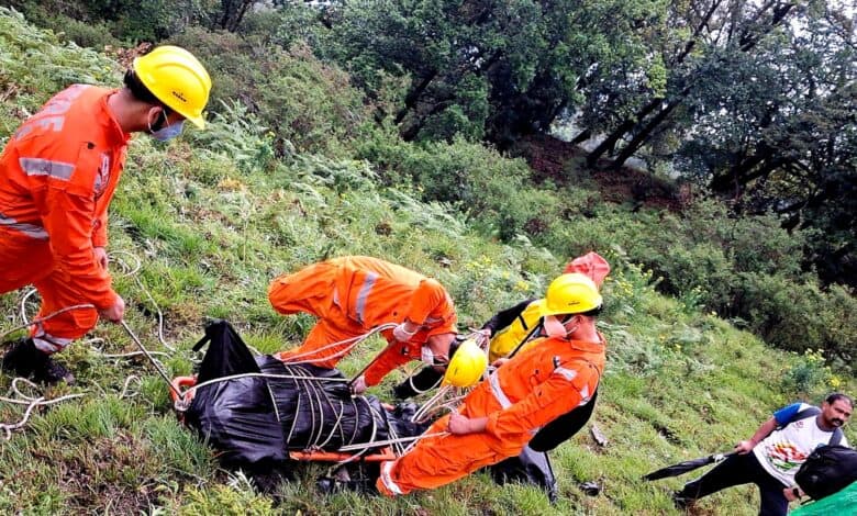NDRF personnel retrieve a body after a helicopter crashed near the Kedarnath shrine in Rudraprayag district of Uttarakhand on Sunday.