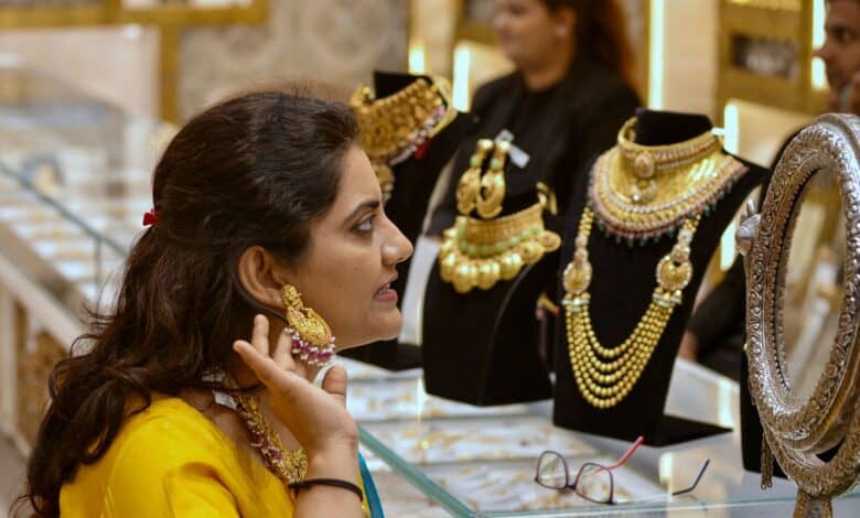 A woman tries out gold jewellery