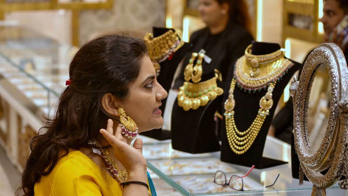 A woman tries out gold jewellery
