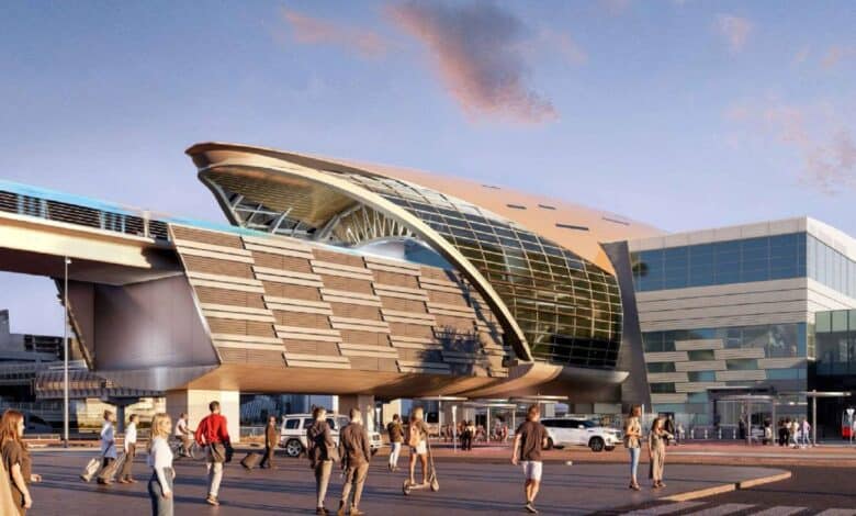 A futuristic architectural design of the Burj Khalifa-Dubai Mall Metro Station expansion in Dubai, featuring a sleek glass and steel structure with pedestrians walking in the foreground during sunset.