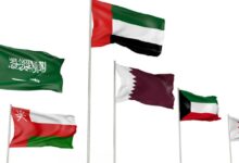 Six national flags of Gulf Cooperation Council (GCC) countries—Saudi Arabia, UAE, Qatar, Kuwait, Oman, and Bahrain—waving on flagpoles against a white background.