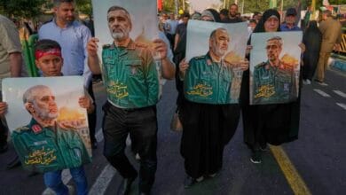 Demonstrators in Tehran carry posters of top Iranian commanders reportedly killed in Israeli strikes, during an Eid al-Ghadir procession on June 14, 2025.