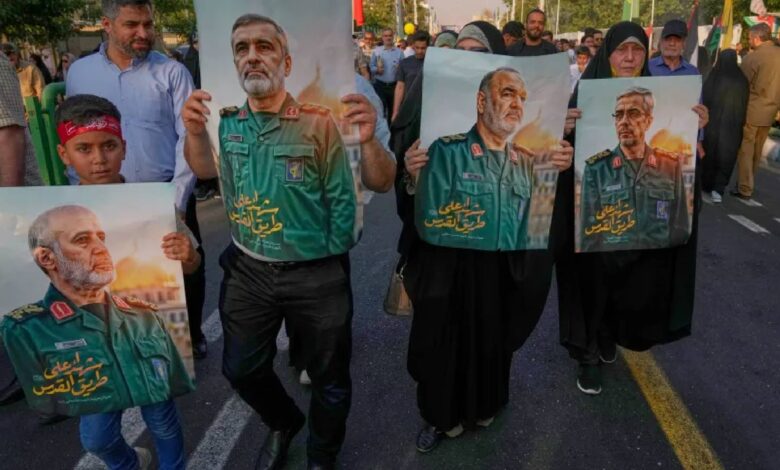 Demonstrators in Tehran carry posters of top Iranian commanders reportedly killed in Israeli strikes, during an Eid al-Ghadir procession on June 14, 2025.
