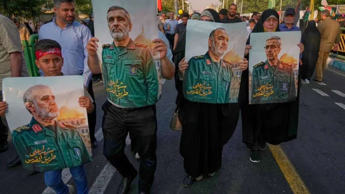 Demonstrators in Tehran carry posters of top Iranian commanders reportedly killed in Israeli strikes, during an Eid al-Ghadir procession on June 14, 2025.