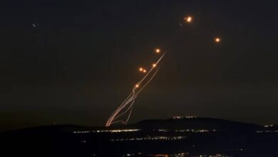 Israel’s Iron Dome missile defence system launches an interceptor during an incoming rocket attack, with smoke trails visible against the evening sky.