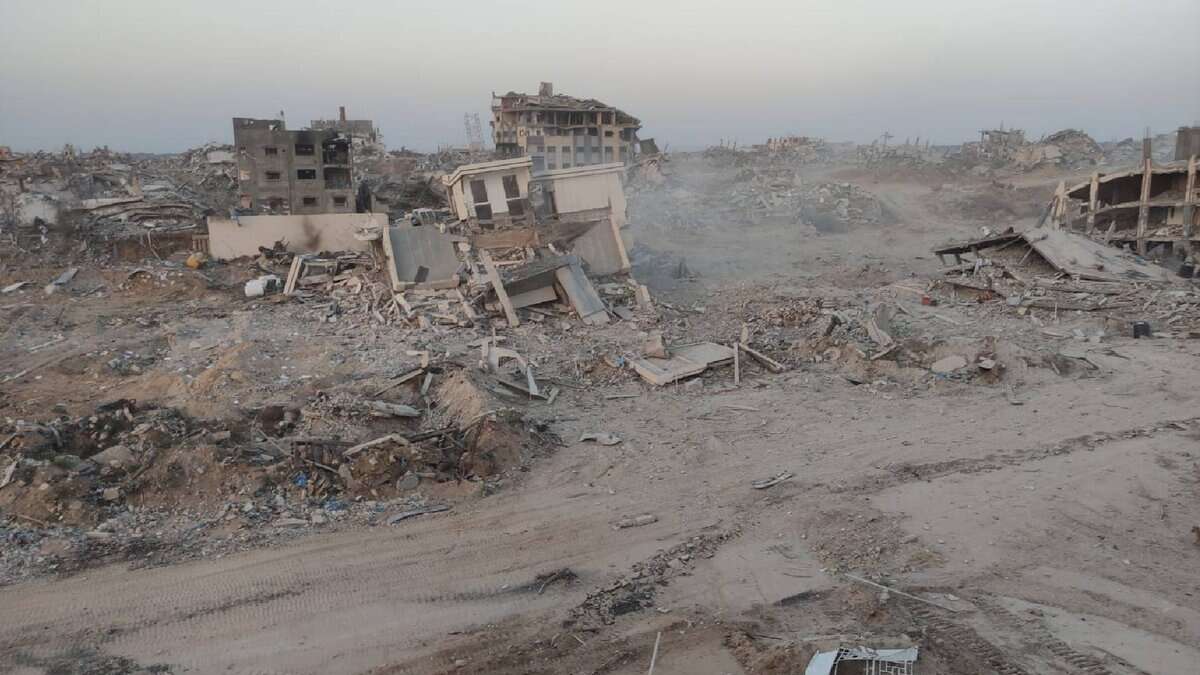 Widespread destruction in the northern Gaza Strip showing the rubble and ruins of the Noura Al-Kaabi Dialysis Centre after it was completely demolished by Israeli forces. Collapsed buildings and debris cover the area.
