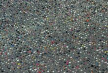 Aerial view of thousands of children's shoes arranged in neat rows across Stadhuisplein (City Hall Square) in Almere, Netherlands, as part of a memorial installation for Palestinian children killed in Gaza.