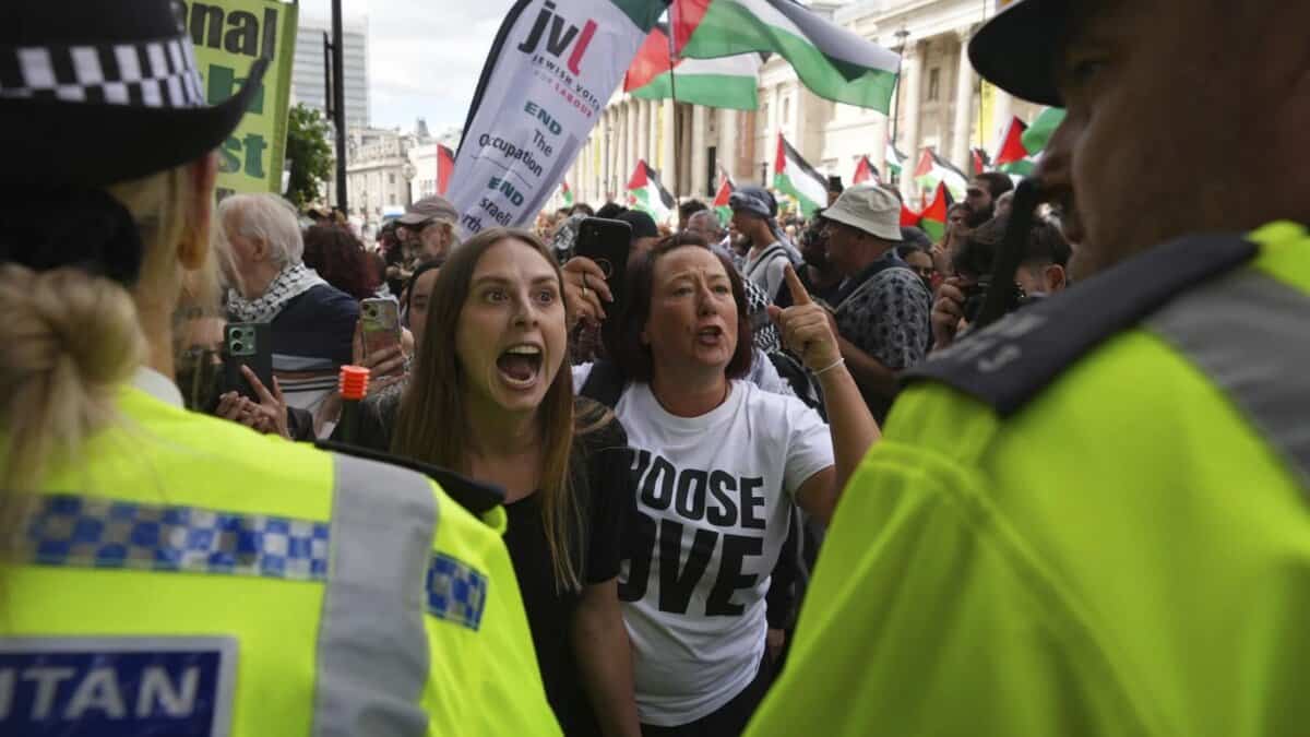 1 of 5 | Demonstrators shout and gesture toward a police line during a protest by Palestine Action group in London, Monday, June 23, 2025. (AP Photo/Frank Augstein)