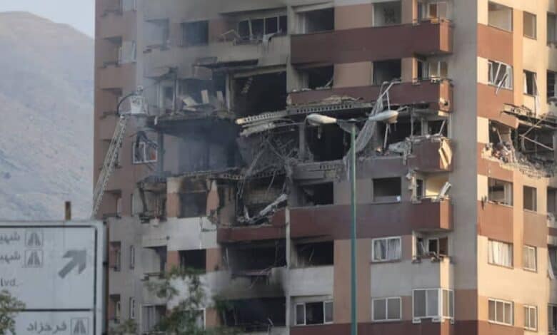 A damaged building in Tehran with shattered windows and debris on the ground following Israel’s strikes on Iran.