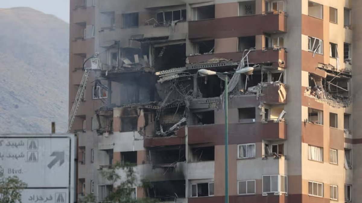 A damaged building in Tehran with shattered windows and debris on the ground following Israel’s strikes on Iran.