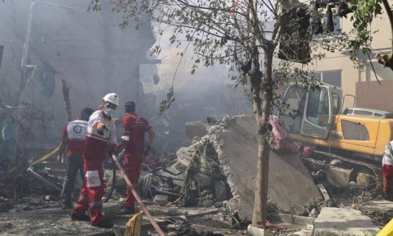 The image of rescue workers from the Iranian Red Crescent Society clear rubble and debris at the site of an explosion in Tehran following an Israeli strike on June 13, 2025.