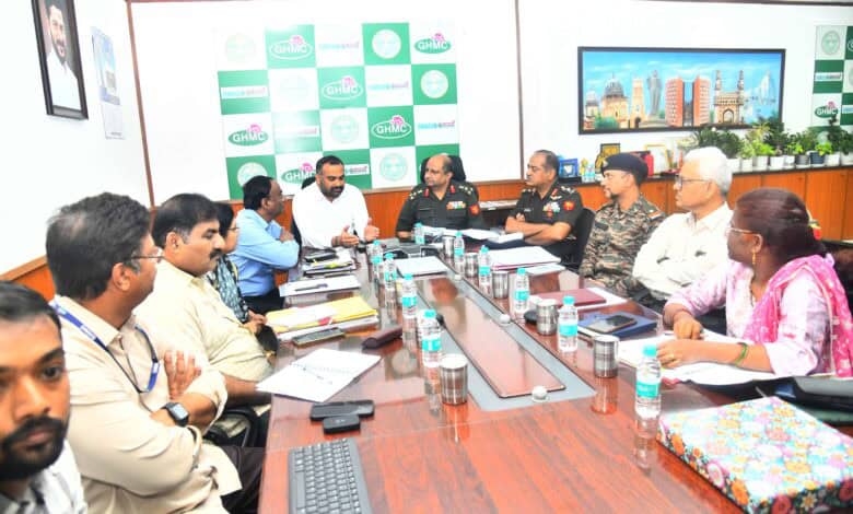 Image of GHMC officials with Defence officials discussing transfer of land.