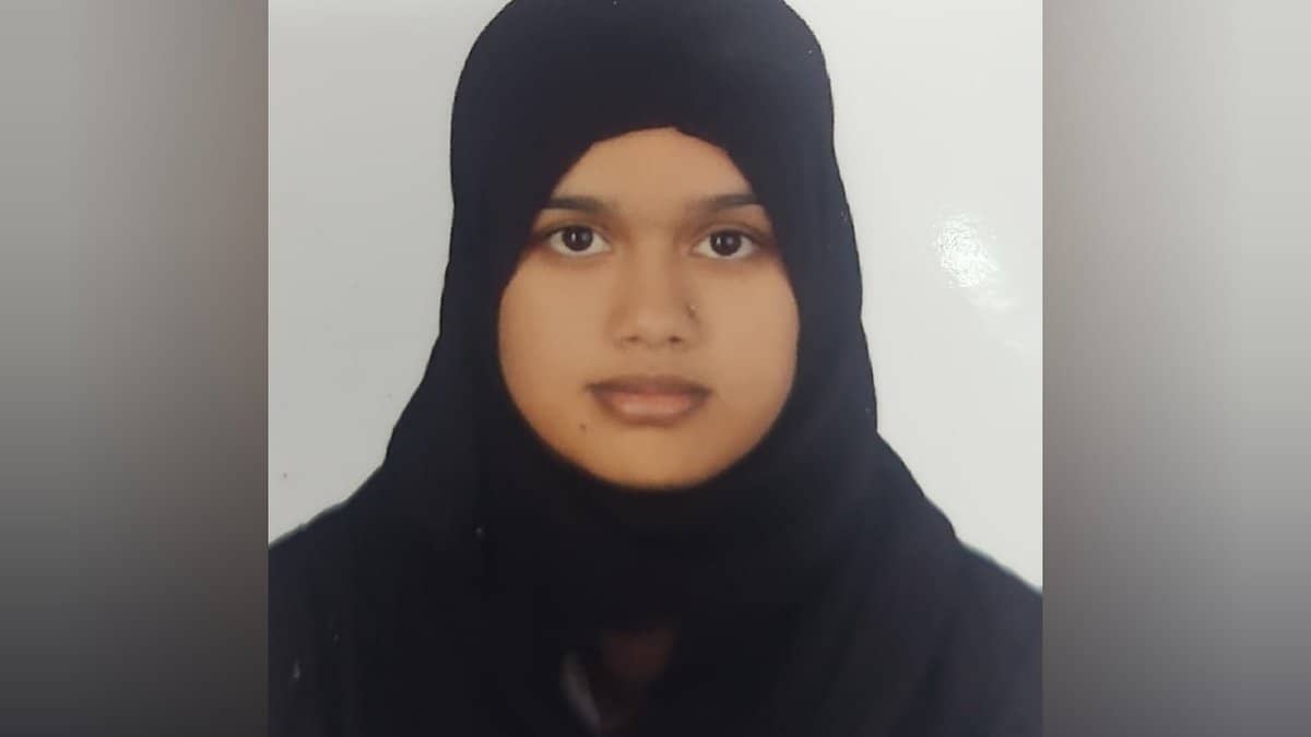Ameena Begum wearing a black hijab, facing the camera in a passport-style photo.