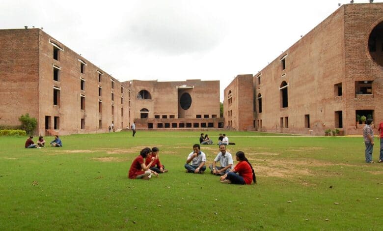 Students sitting on the lawn at the iconic red-brick campus of IIM Ahmedabad.