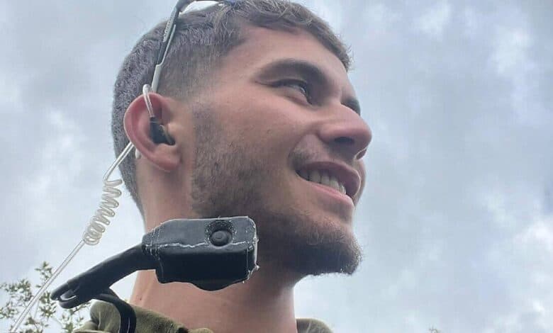 The image of a Reei Biran, 21-year-old IDF squad commander in the Golani Reconnaissance Unit, wearing military gear and communication equipment.