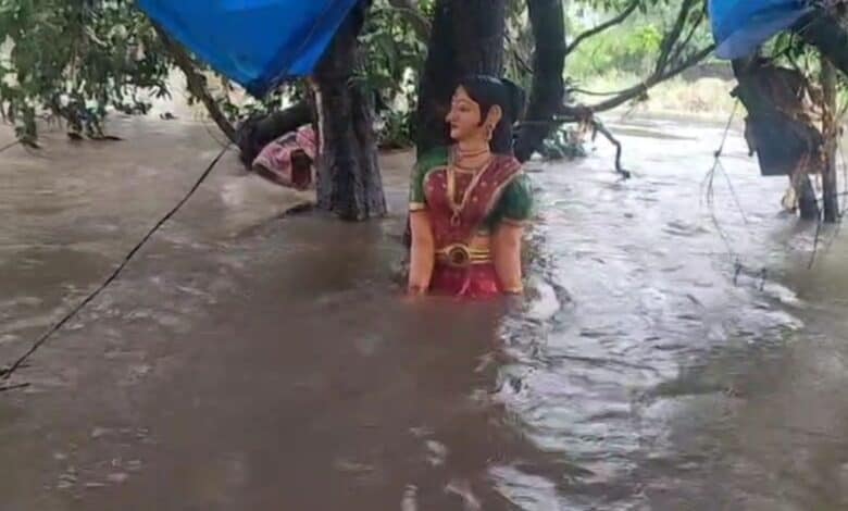 The image shows Sita's statue half-submerged in flood waters in Parnashala on Friday, July 24, 2025.